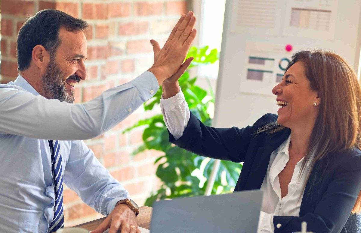 Two shareholders giving each other a high five in agreement